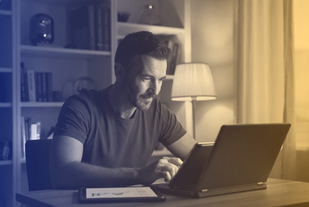An adult learner studying at home in the evening